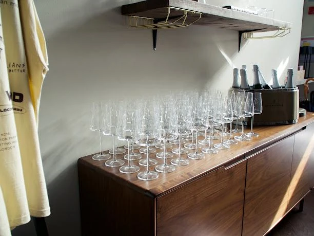 Calici allineati sulla credenza in legno, pronti per la degustazione